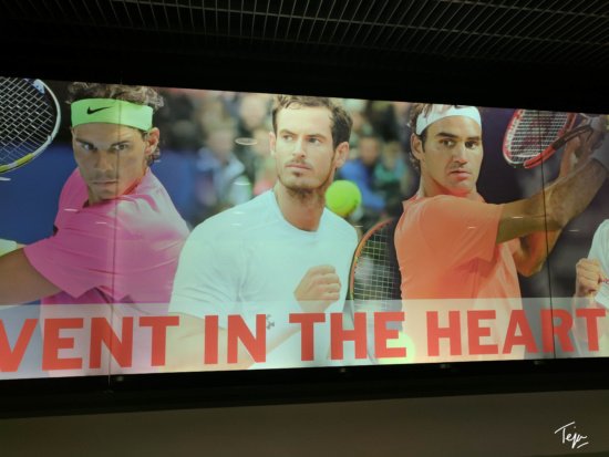 a sign with a group of men holding tennis rackets