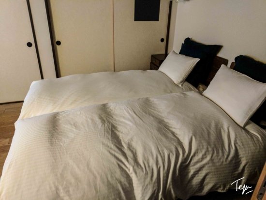 two beds with white sheets
