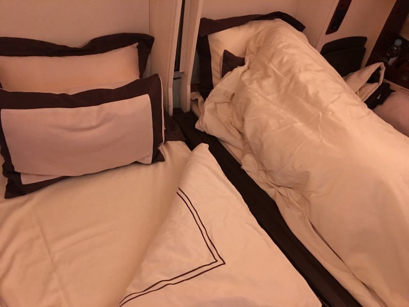a bed with pillows and a pillow on it