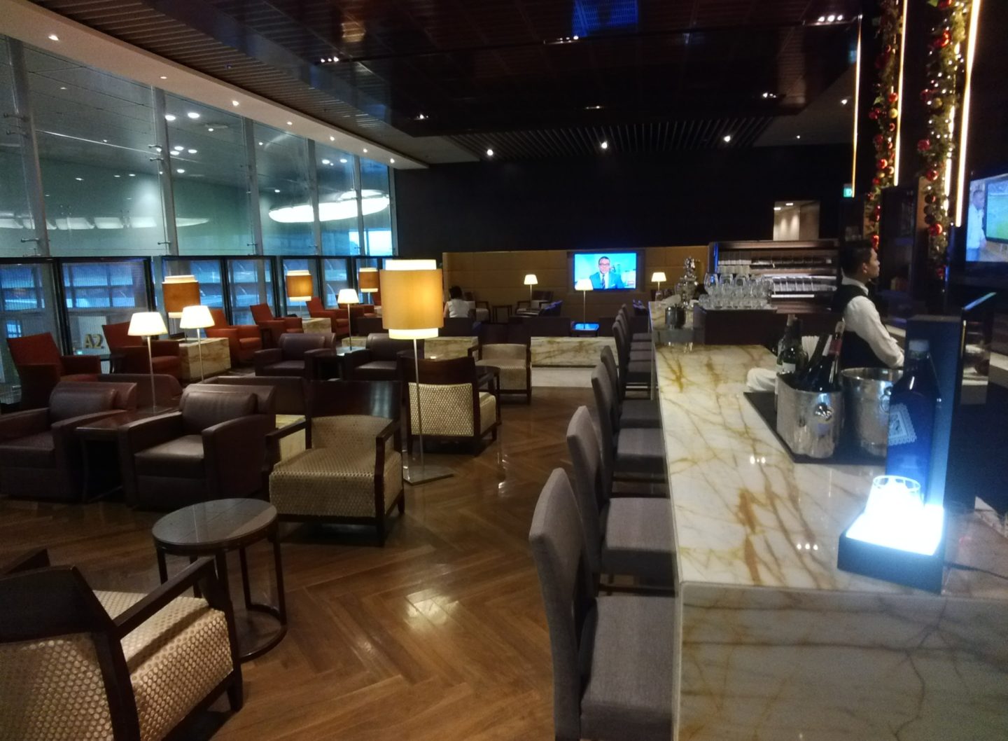 a room with a bar and chairs