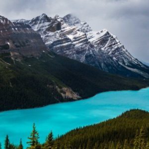a blue lake surrounded by mountains with Peyto Lake in the background