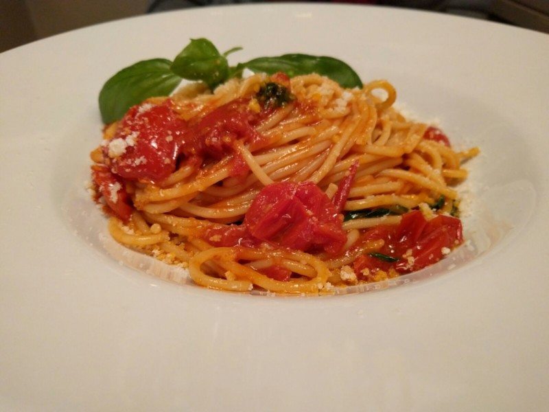 a plate of spaghetti with tomato sauce and basil