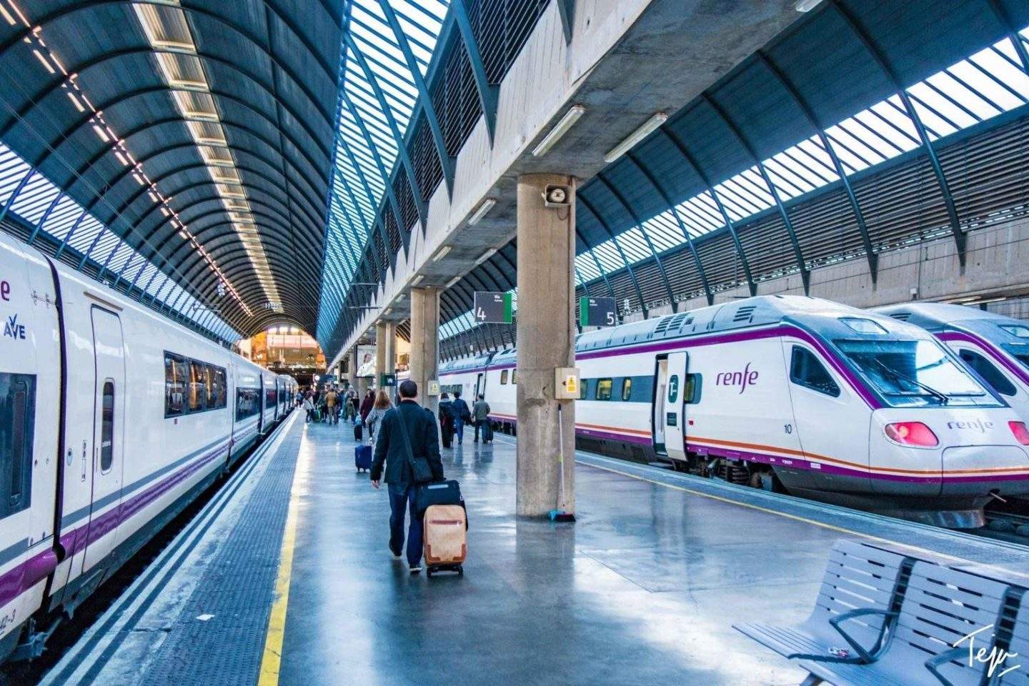 a train station with people and luggage