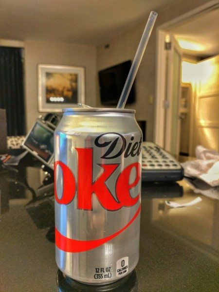 a can with a straw in it