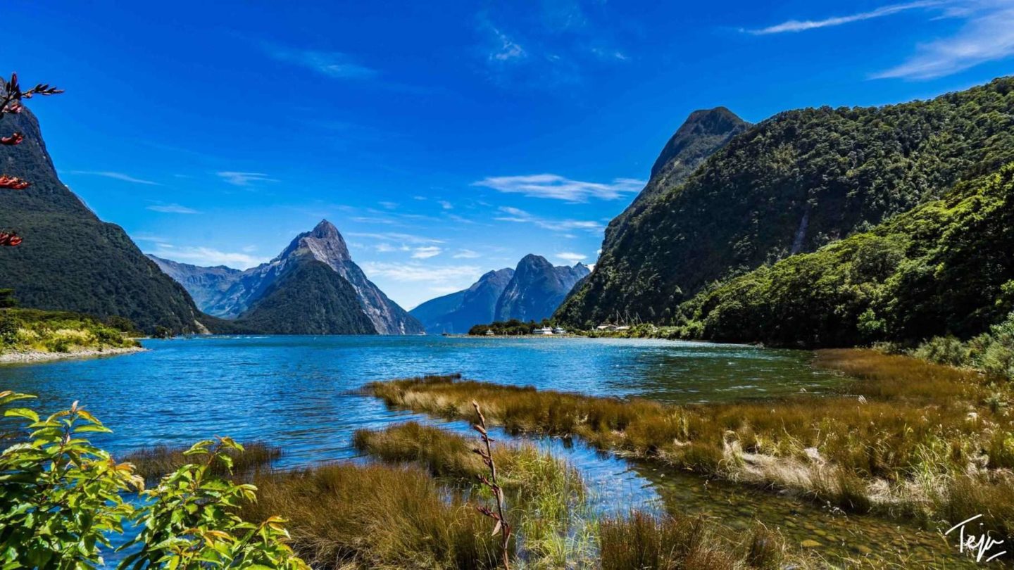 a body of water with mountains in the background