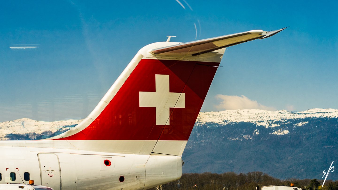 the tail of an airplane with a white cross on it