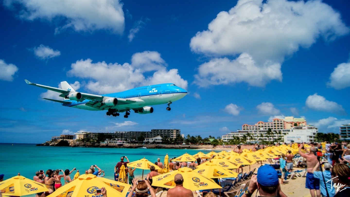 a plane flying over a beach