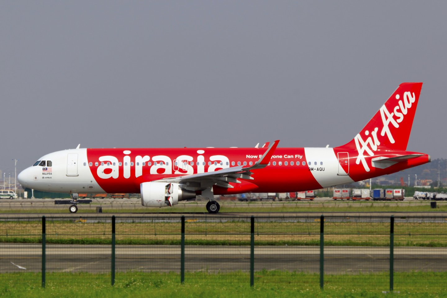 a red and white airplane on a runway