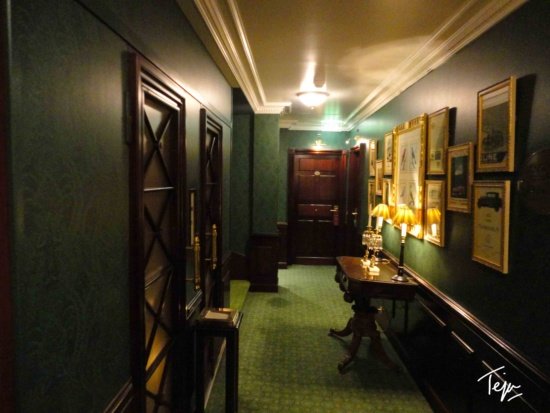 a hallway with a table and lamps