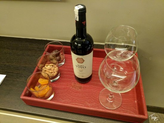 a tray with a bottle and glasses on it