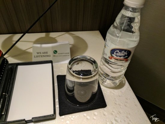 a glass and a bottle of water on a table