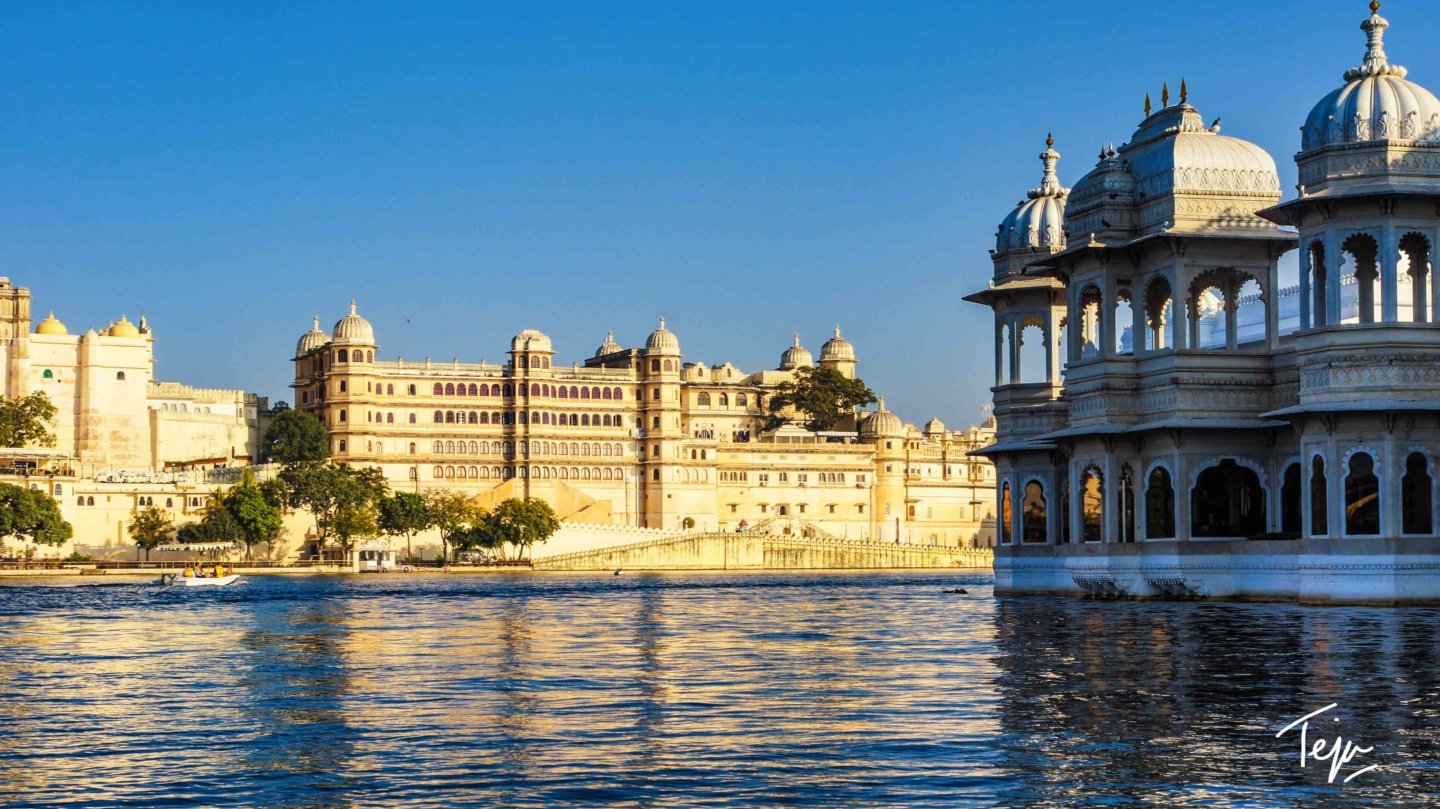 a large building with many windows and a body of water