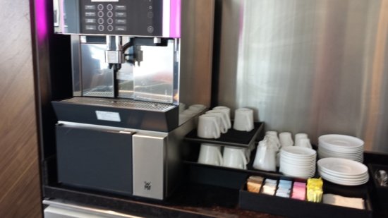 a coffee machine with cups and saucers