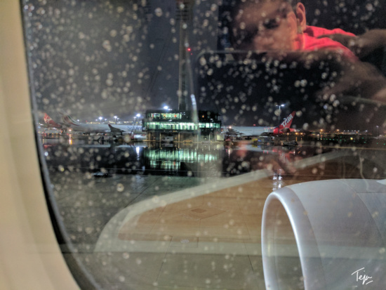 a window with a view of planes and buildings