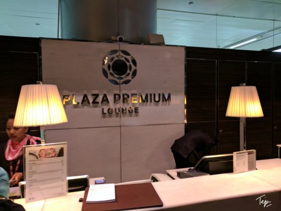 a reception desk with lamps and a sign