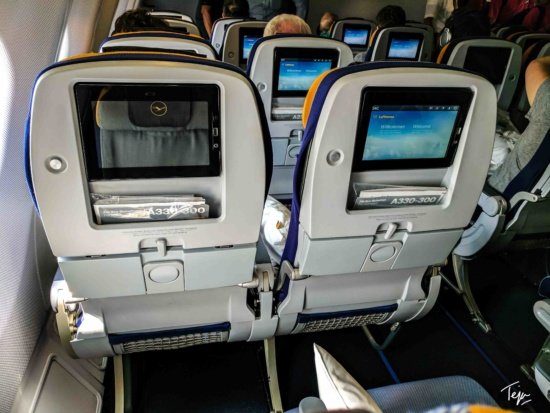 seats in an airplane with monitors