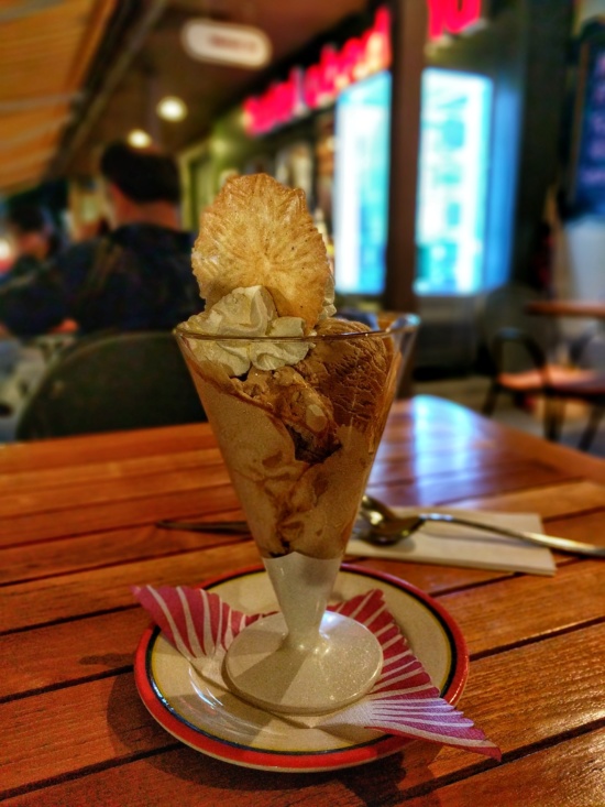 a ice cream sundae in a glass on a table