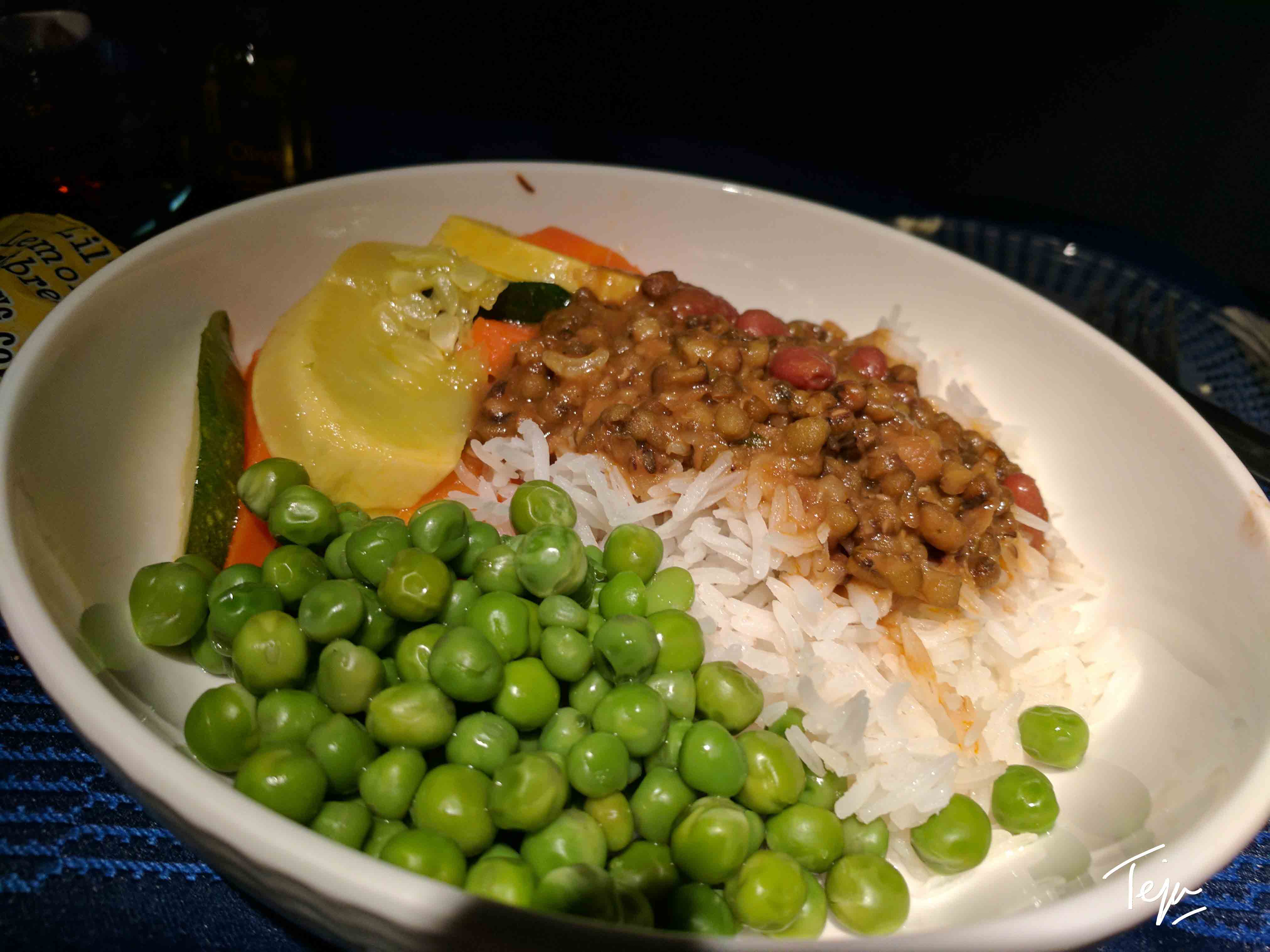 a bowl of food with peas and beans