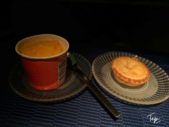 a cup of soup and a pie on plates