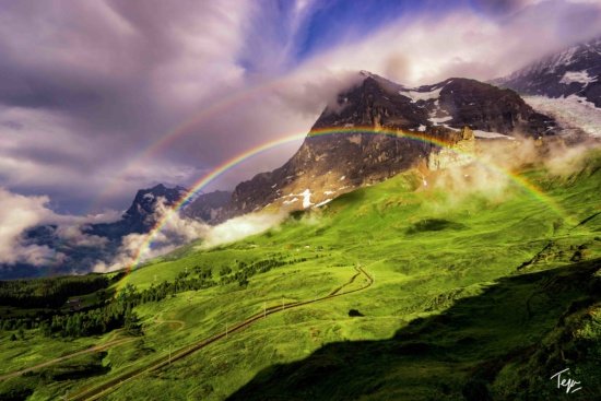 a rainbow over a mountain