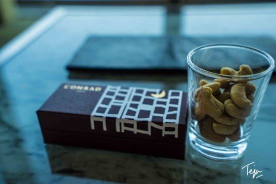a glass of nuts and a box of cashews