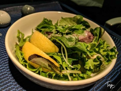 a bowl of salad with lemons