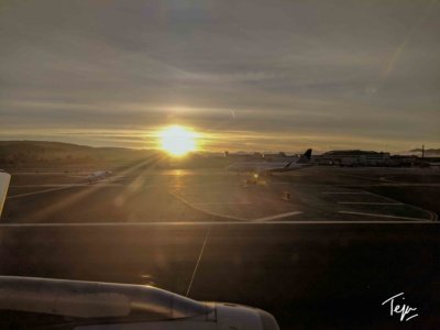 a sunset over an airport runway