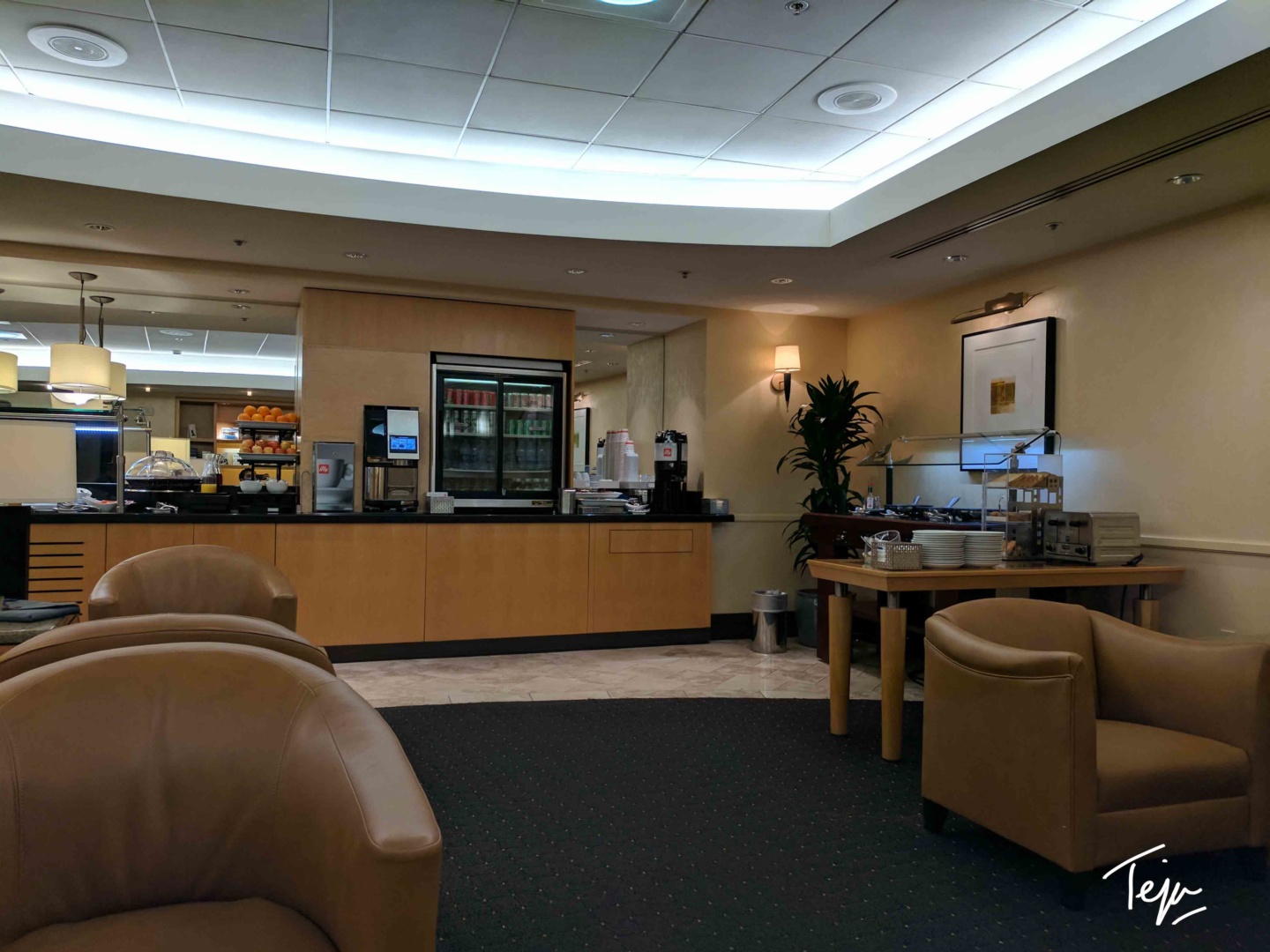 a room with a buffet and chairs