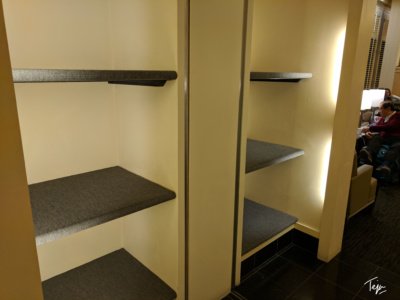 a room with shelves and a door