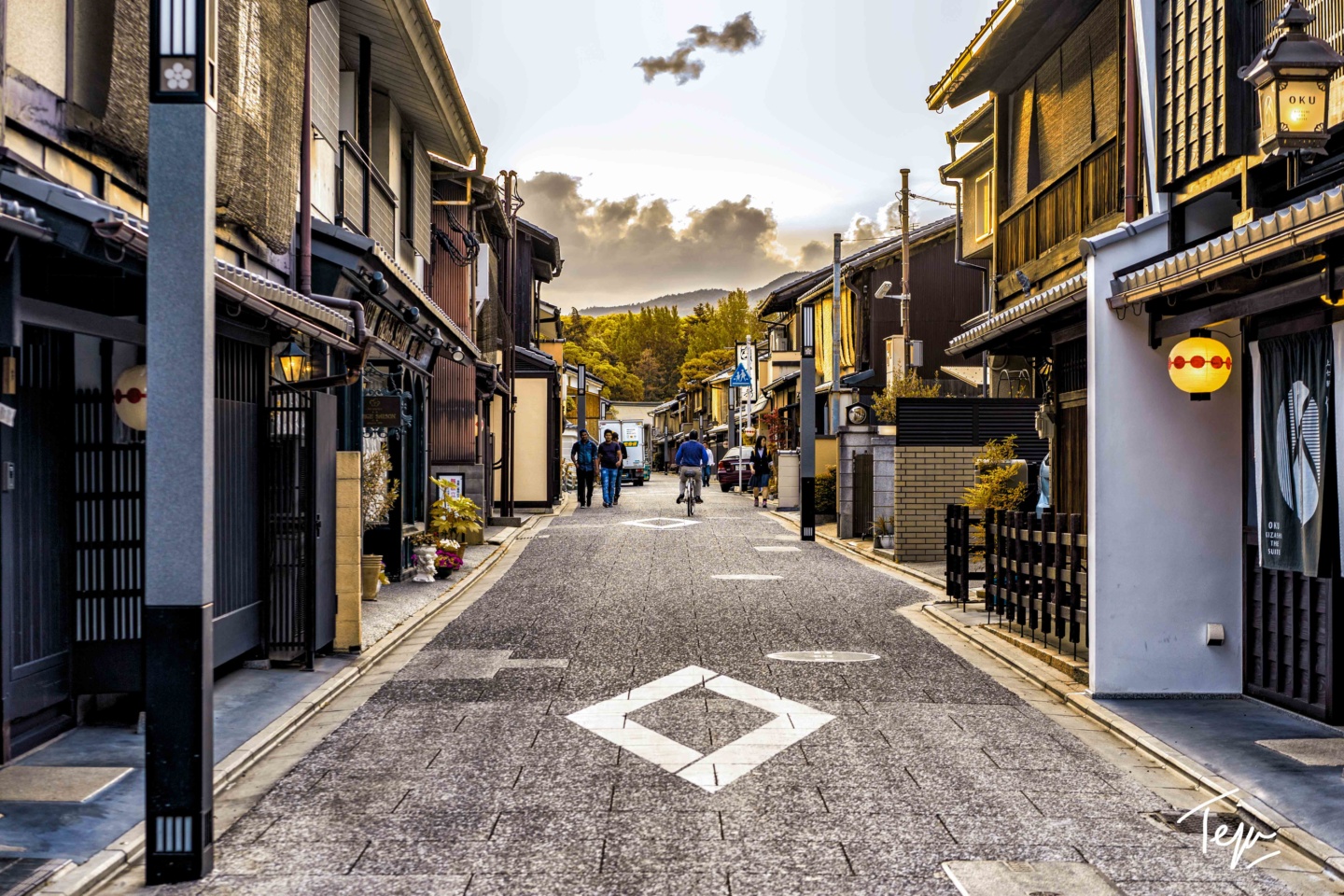 a street with buildings and people walking