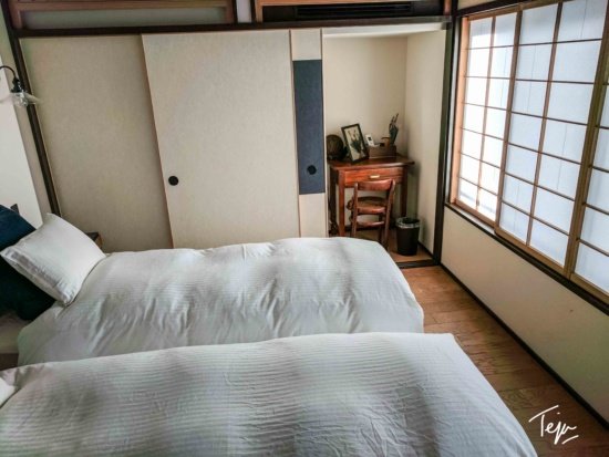 a room with two beds and a sliding door