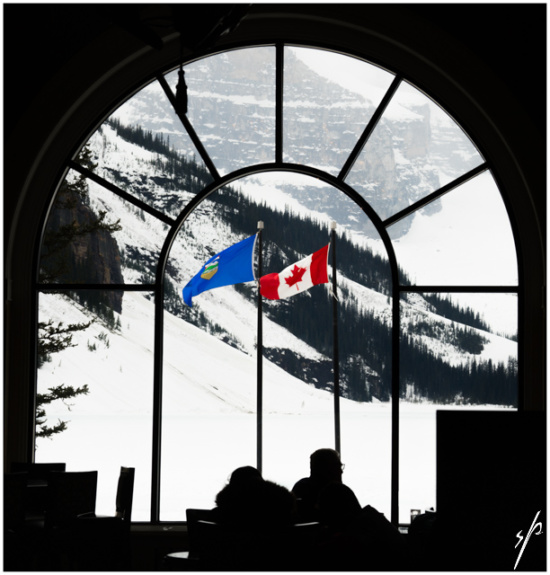 a window with flags in the snow