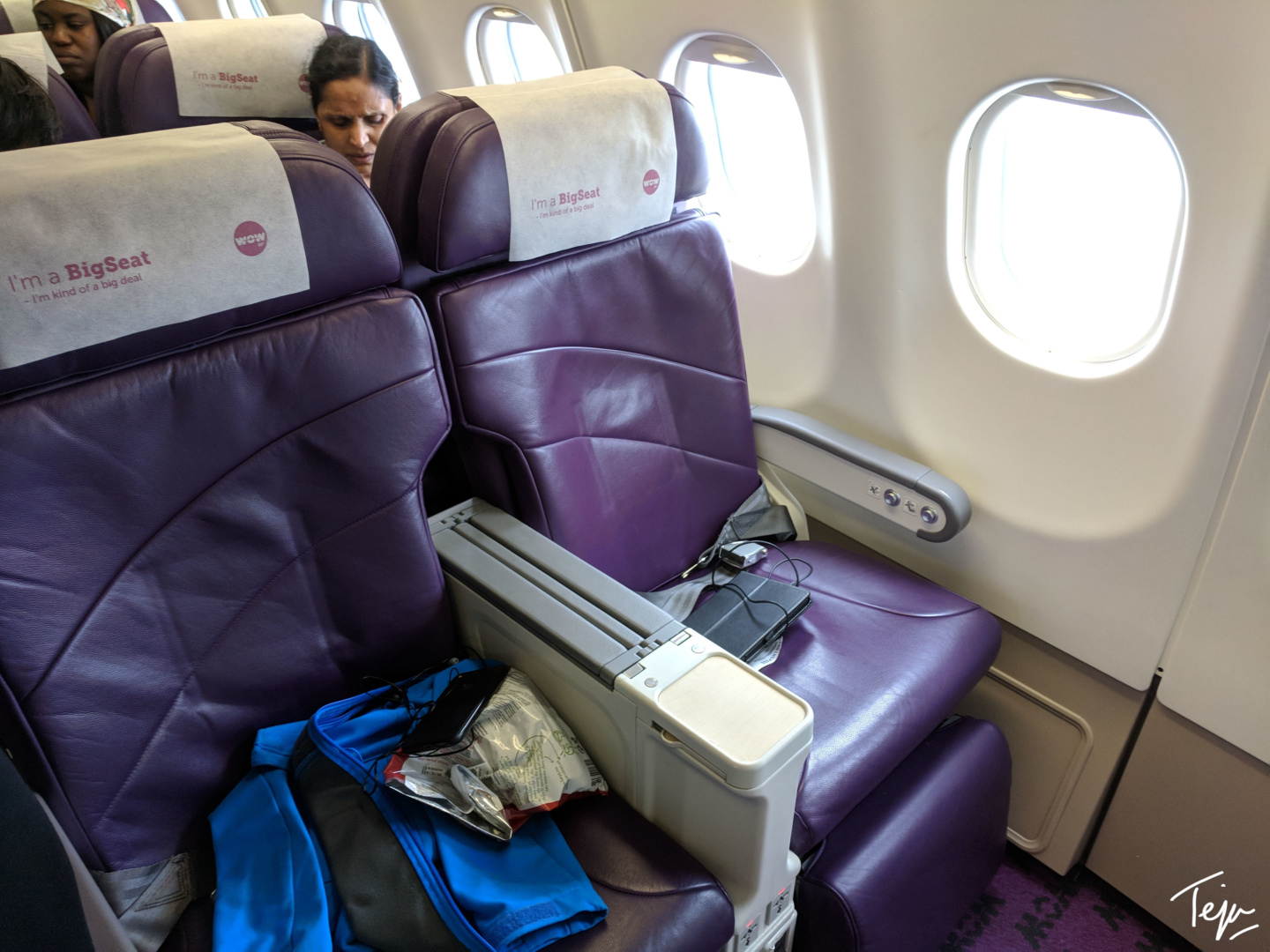 a woman sitting in a chair in an airplane
