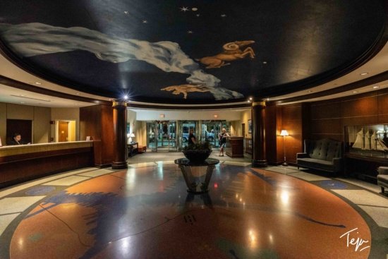 a lobby with a mural on the ceiling