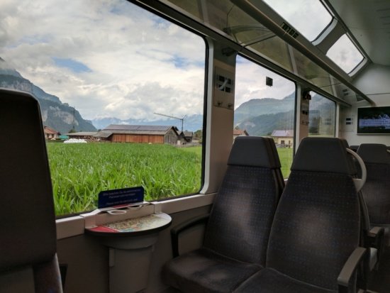 a view of a field from a train