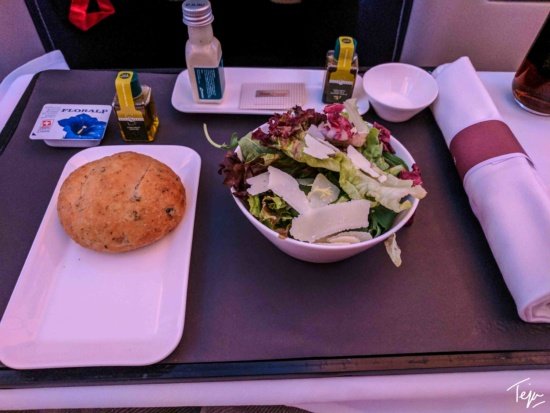 a salad and bread on a tray