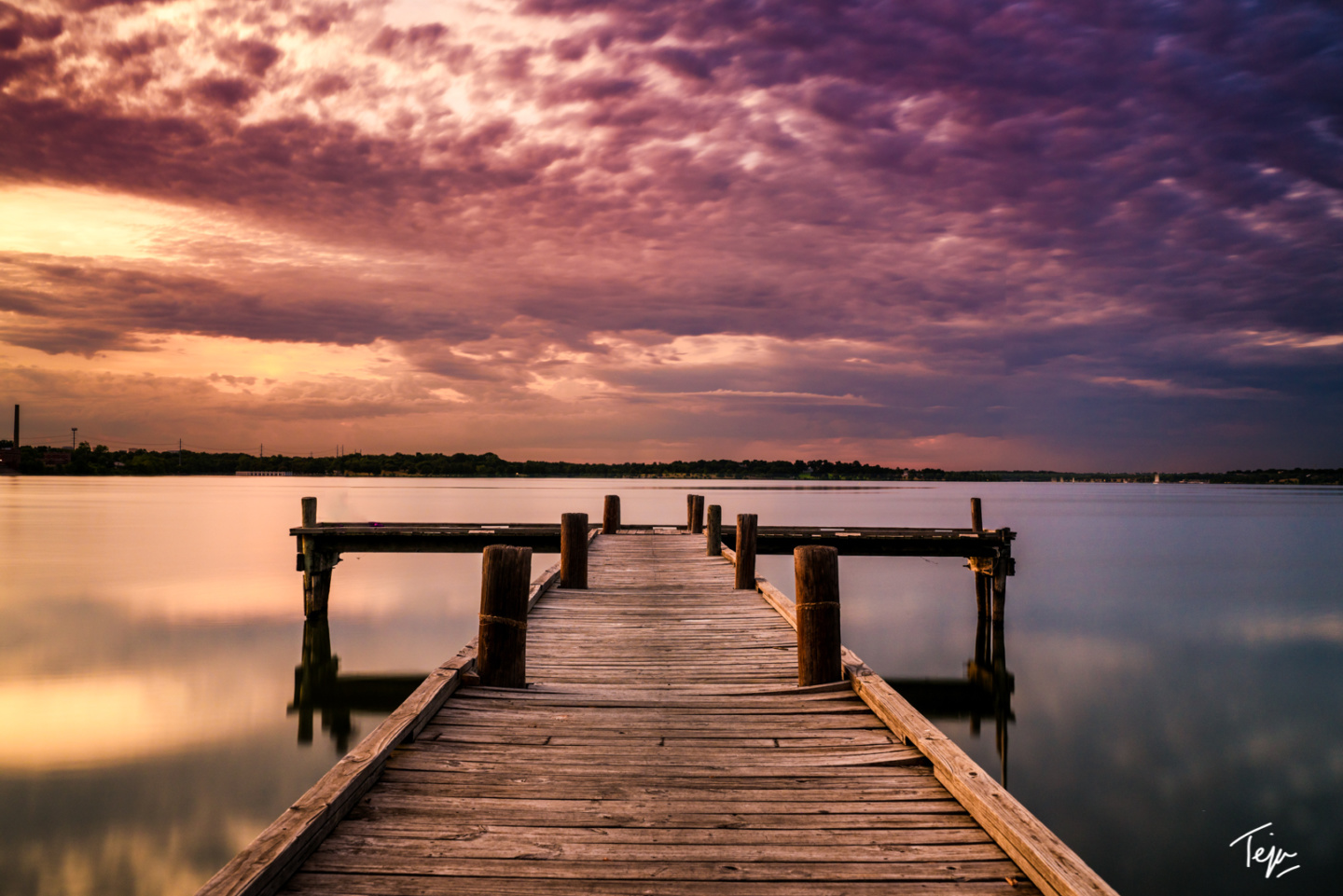 a wooden dock on a lake