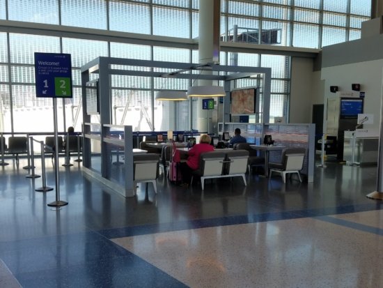 people sitting at tables in a terminal