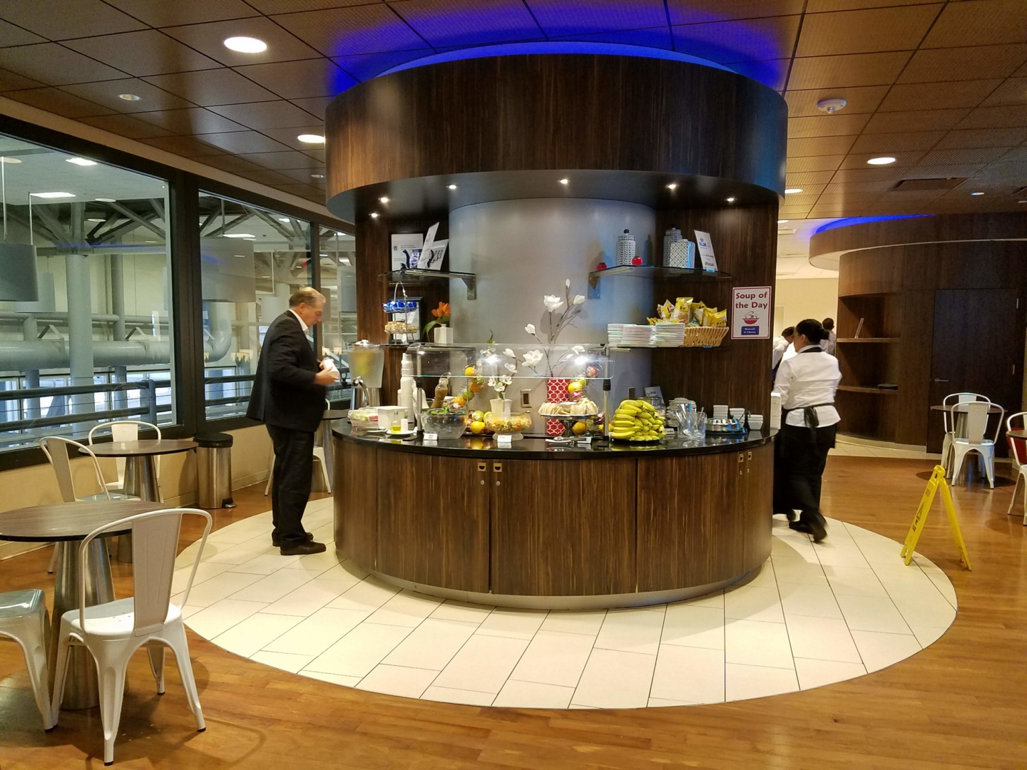 a man standing at a counter in a room with people