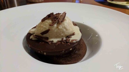 a chocolate cookie with a scoop of ice cream on top