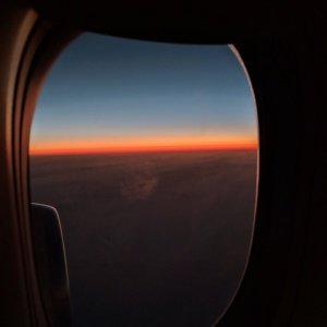 a view of the sunset from an airplane window