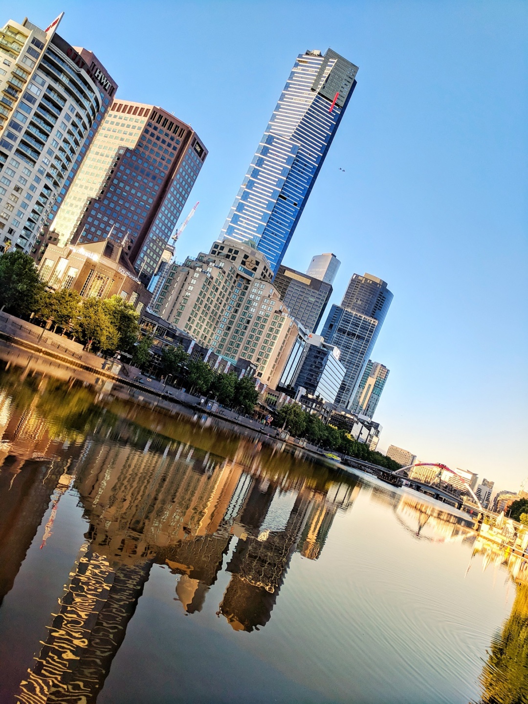 a body of water with a city skyline in the background