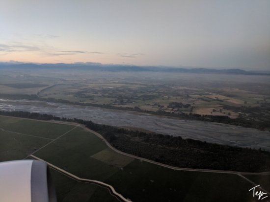 a view of a river and land from an airplane