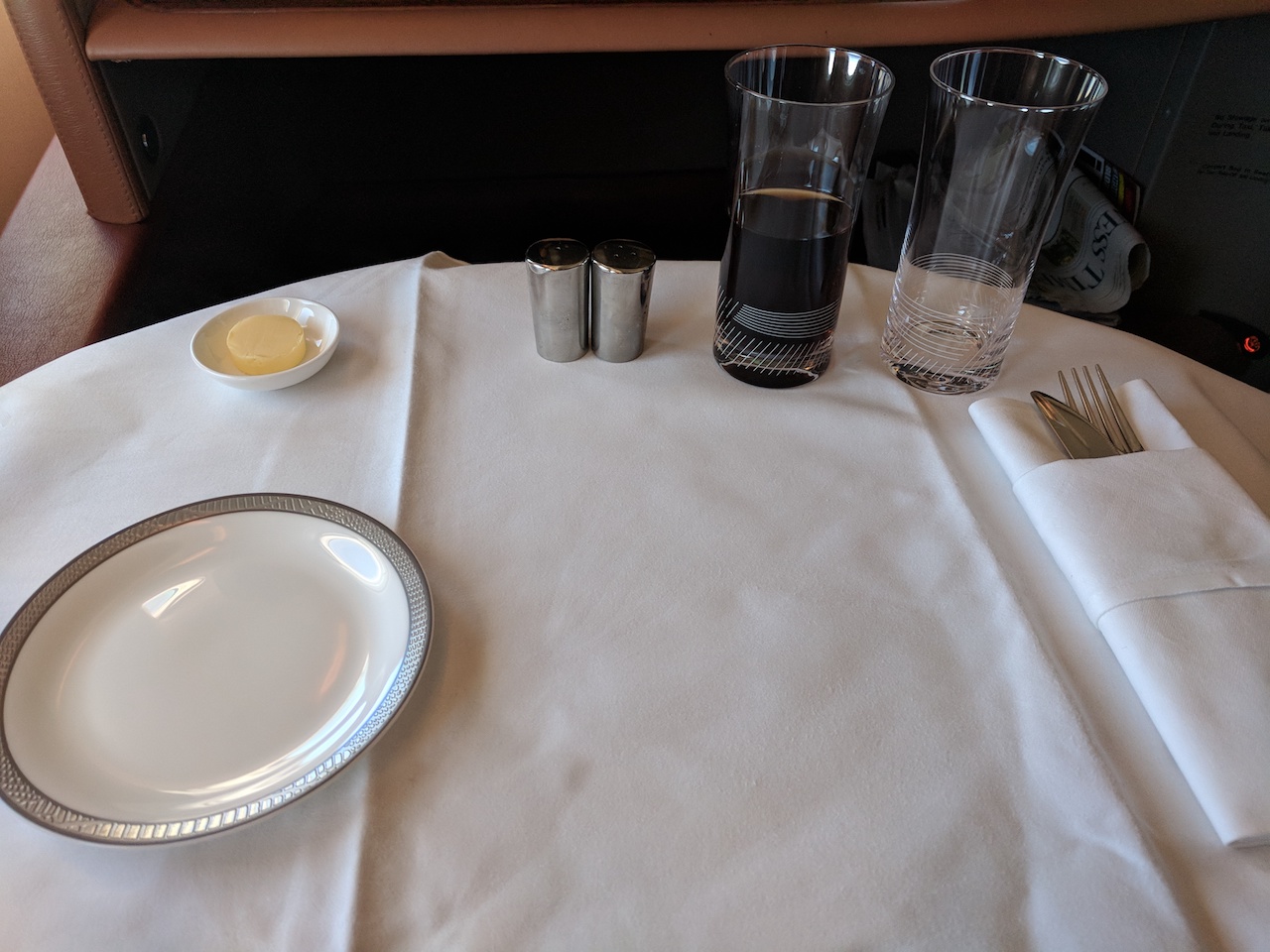a table with a plate and glasses on it