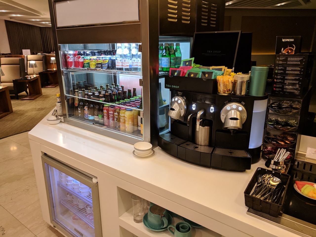 a coffee machine and beverage dispenser on a counter