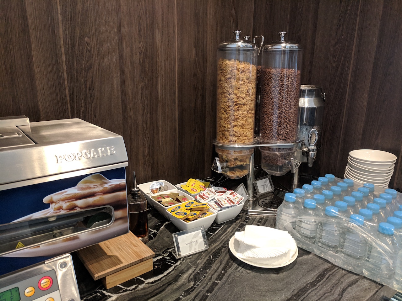 a breakfast buffet with cereals and other food items