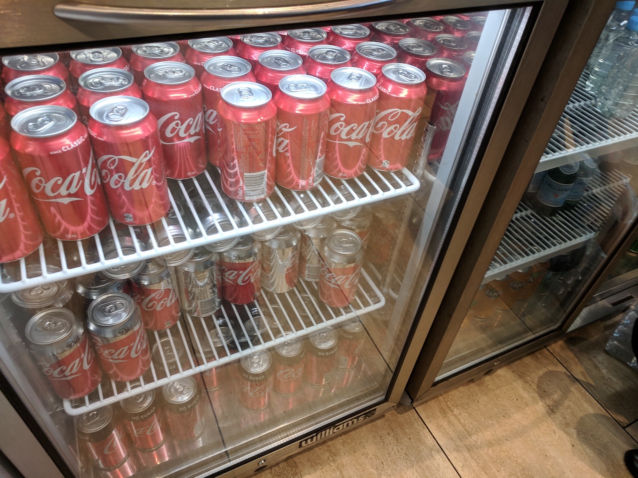 a refrigerator full of soda cans