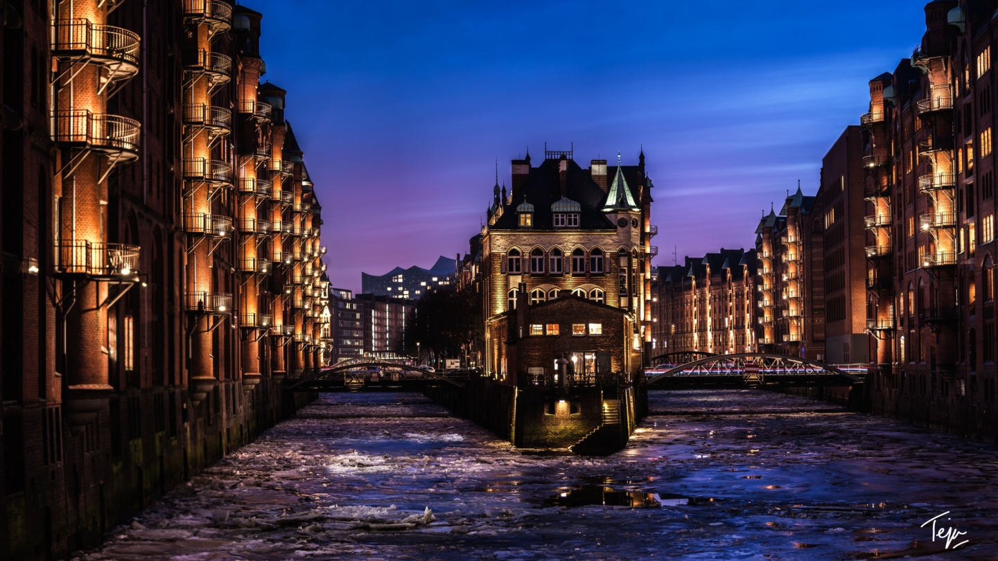 a river with buildings and lights
