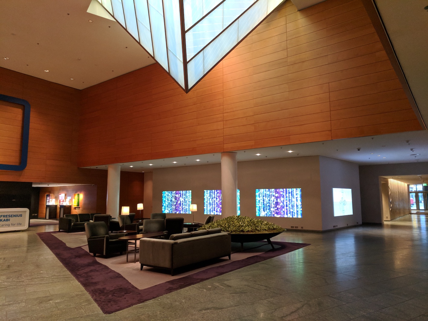 a lobby with a large ceiling and a large window
