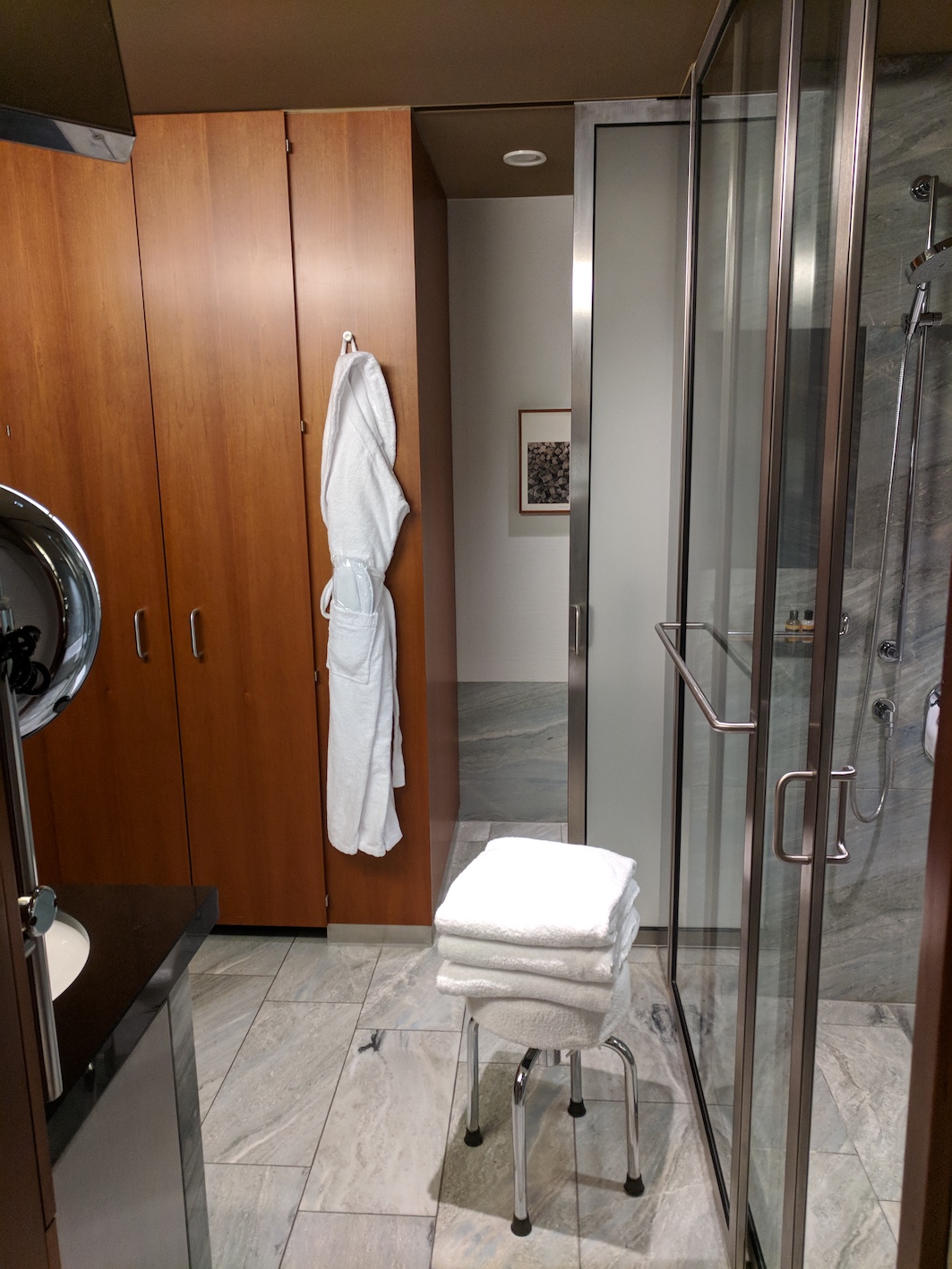 a bathroom with a shower and a towel rack